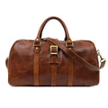 Brown leather duffel bag with gold accents on a white background