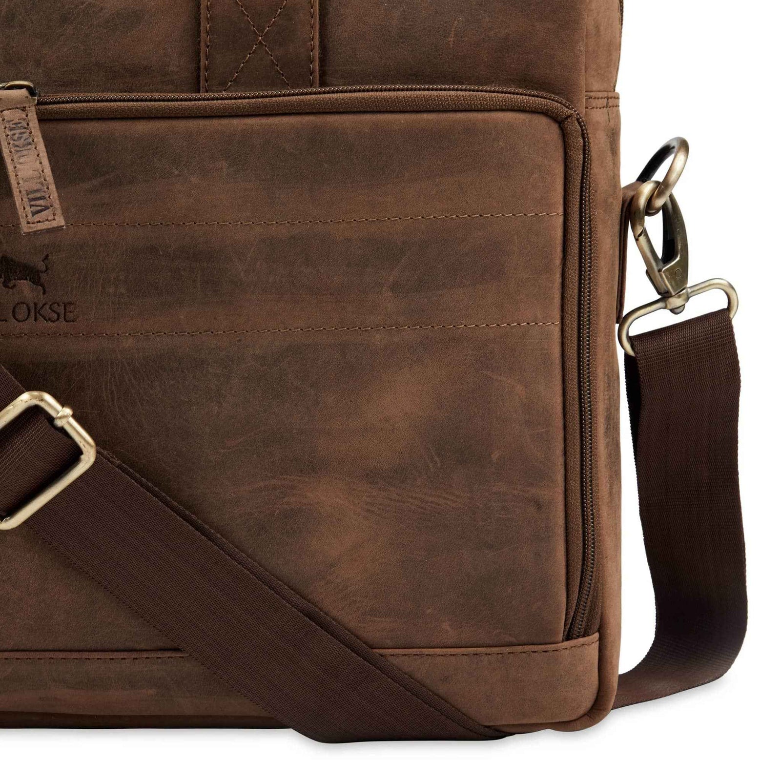 leather-laptop-bag-closeup-metal-clips-and-shoulder-strap - VILL OKSE
